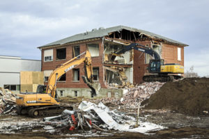 Demolishing a school with excavators